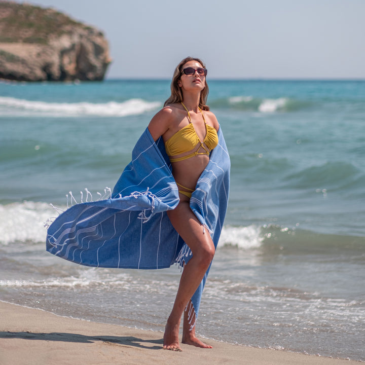 Bodrum Interiors Turkish beach towel on the beach in Antalya, Turkey