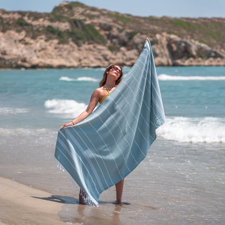 Reseda green Turkish beach towel on the beach in Antalya, Turkey
